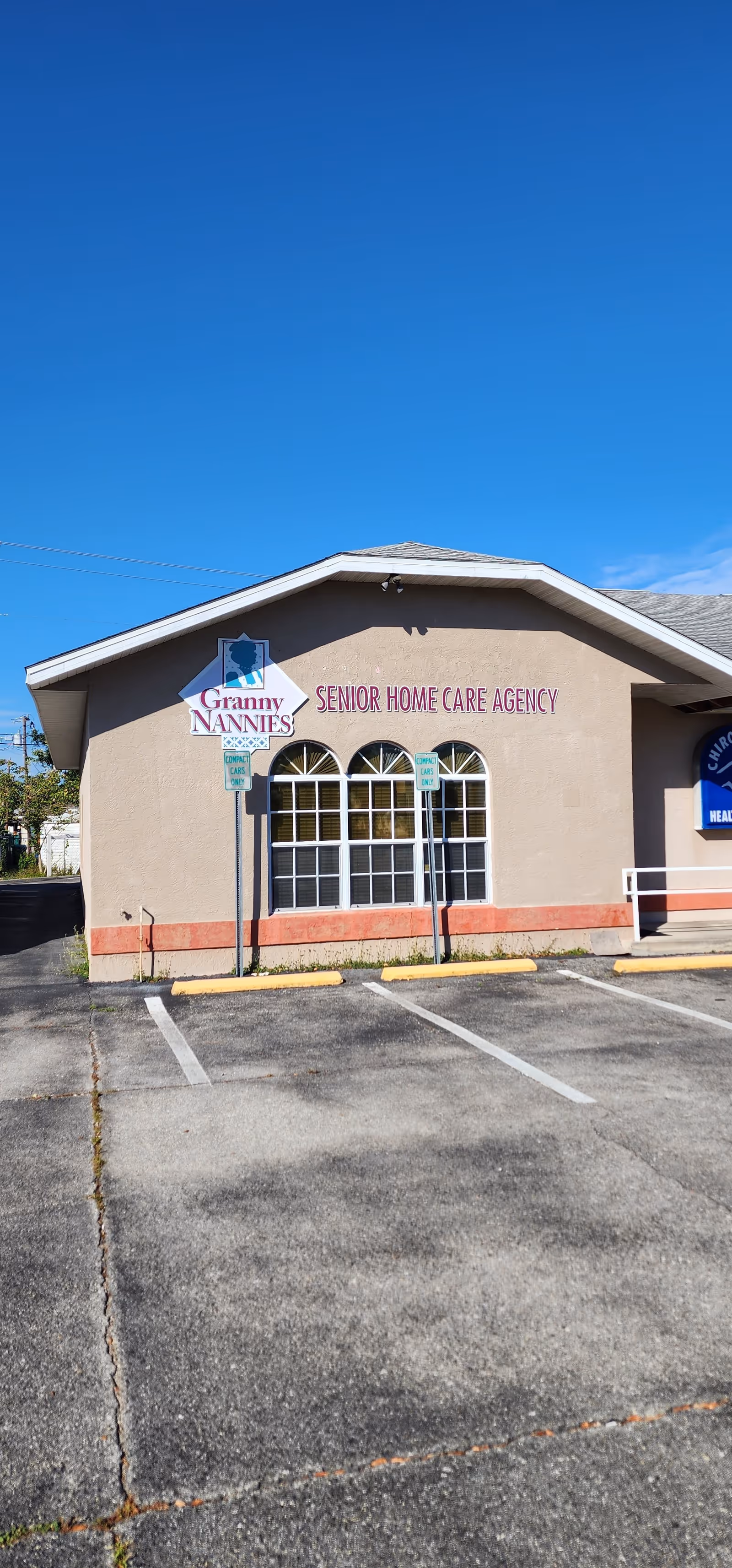 Exterior view of Granny Nannies Senior Home Care Agency building with signage.