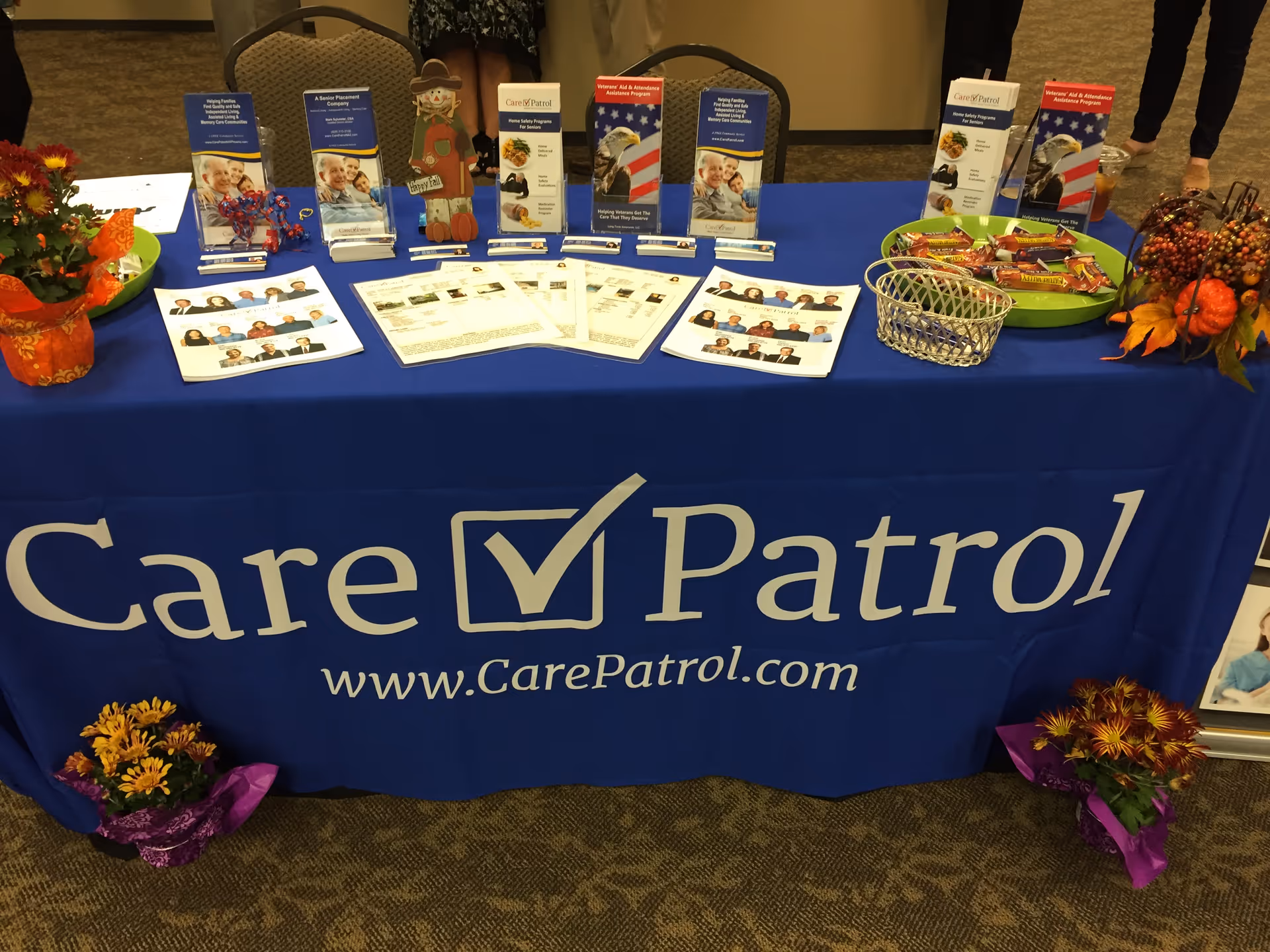 CarePatrol of Northwest Phoenix booth with blue banner and brochures on a display table.