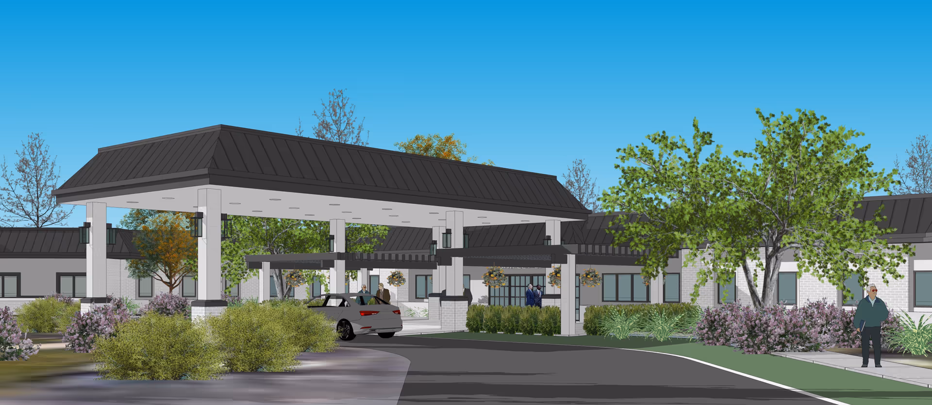 Exterior view of Shipley Living showing a covered entrance, drive lanes, and landscaped surroundings.
