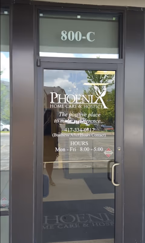 Glass door entrance for Phoenix Home Care & Hospice displaying 800-C and logo.