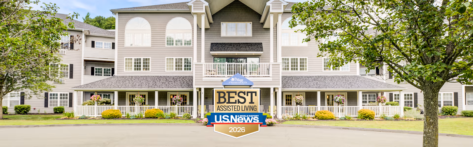 Front view of a grey assisted living building with a Best Assisted Living sign.