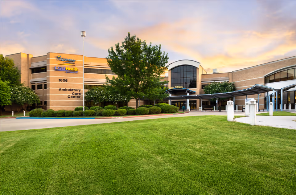 Exterior view of Ochsner LSU Health Ambulatory Care Center with green lawn and entrance.