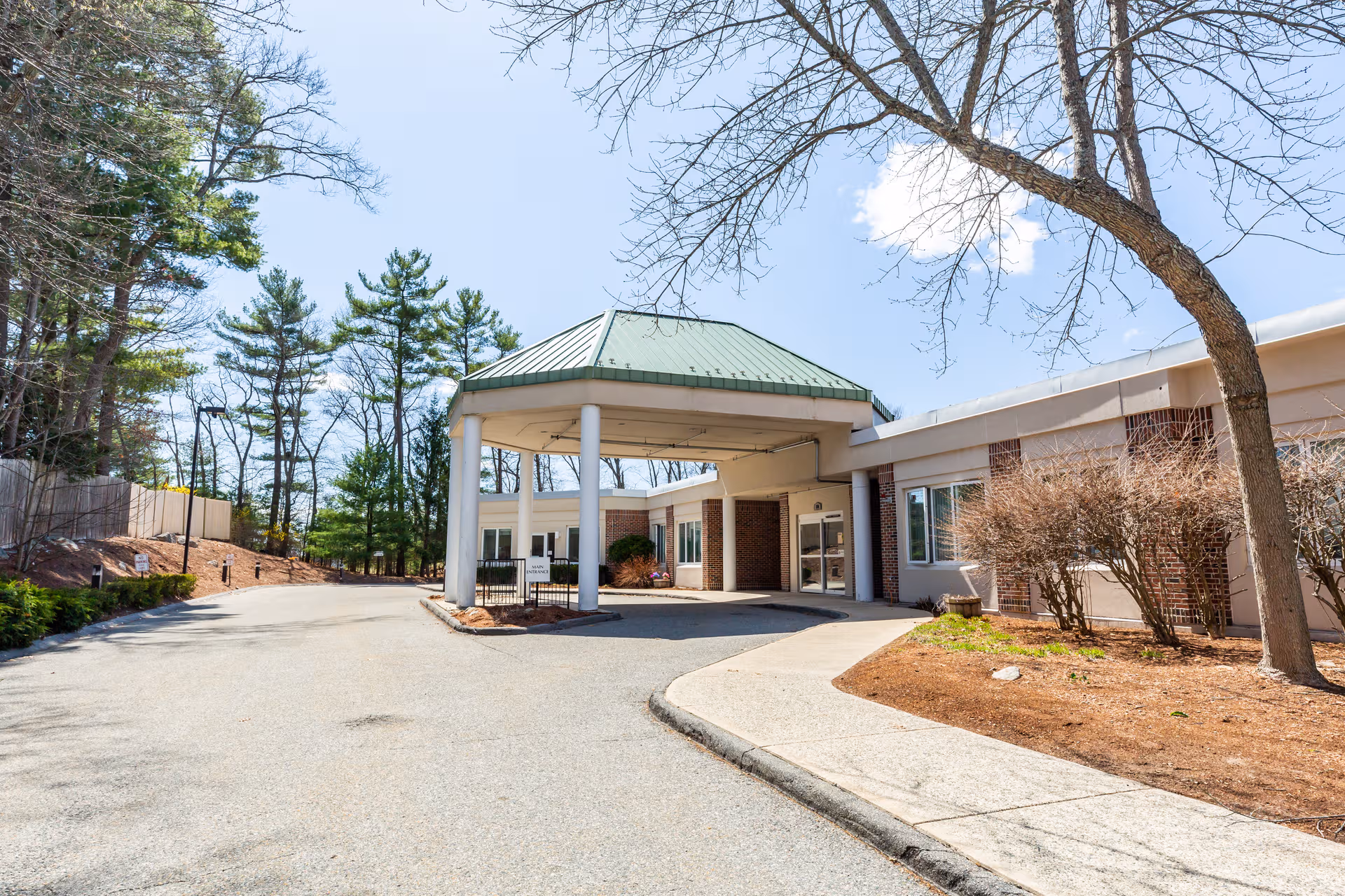 Entrance to a senior living facility with a covered drive-through portico.