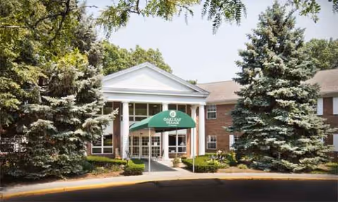 Front entrance of Oakleaf Village of Toledo with a green awning.
