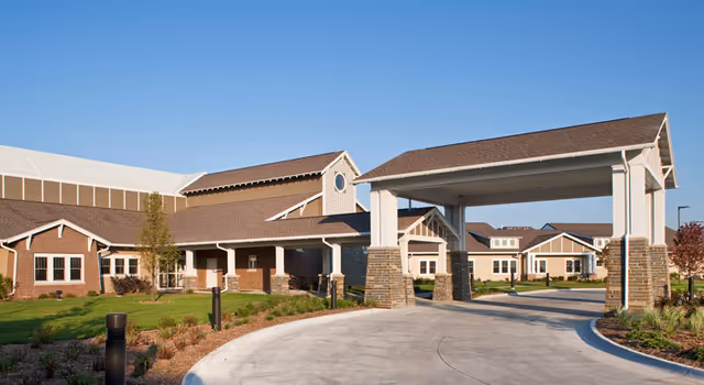 Exterior view of Southlake Village Rehabilitation & Care Center with a covered entrance and driveway.
