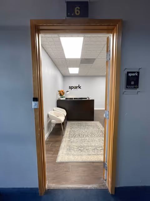 Entering Spark Home Care lobby with reception desk and seating area.