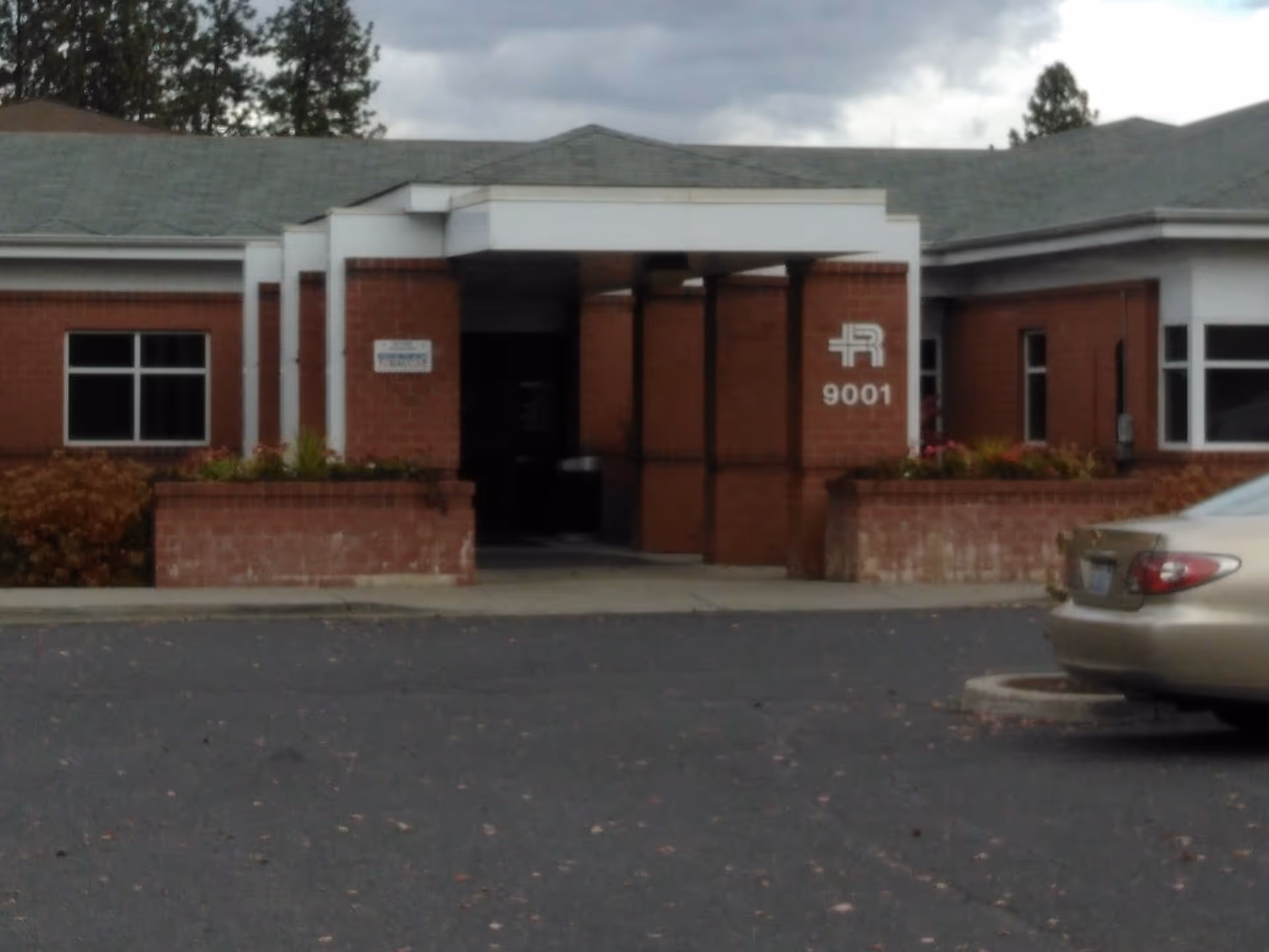 MultiCare Rockwood Northpointe entrance with brick facade and a car in the parking lot