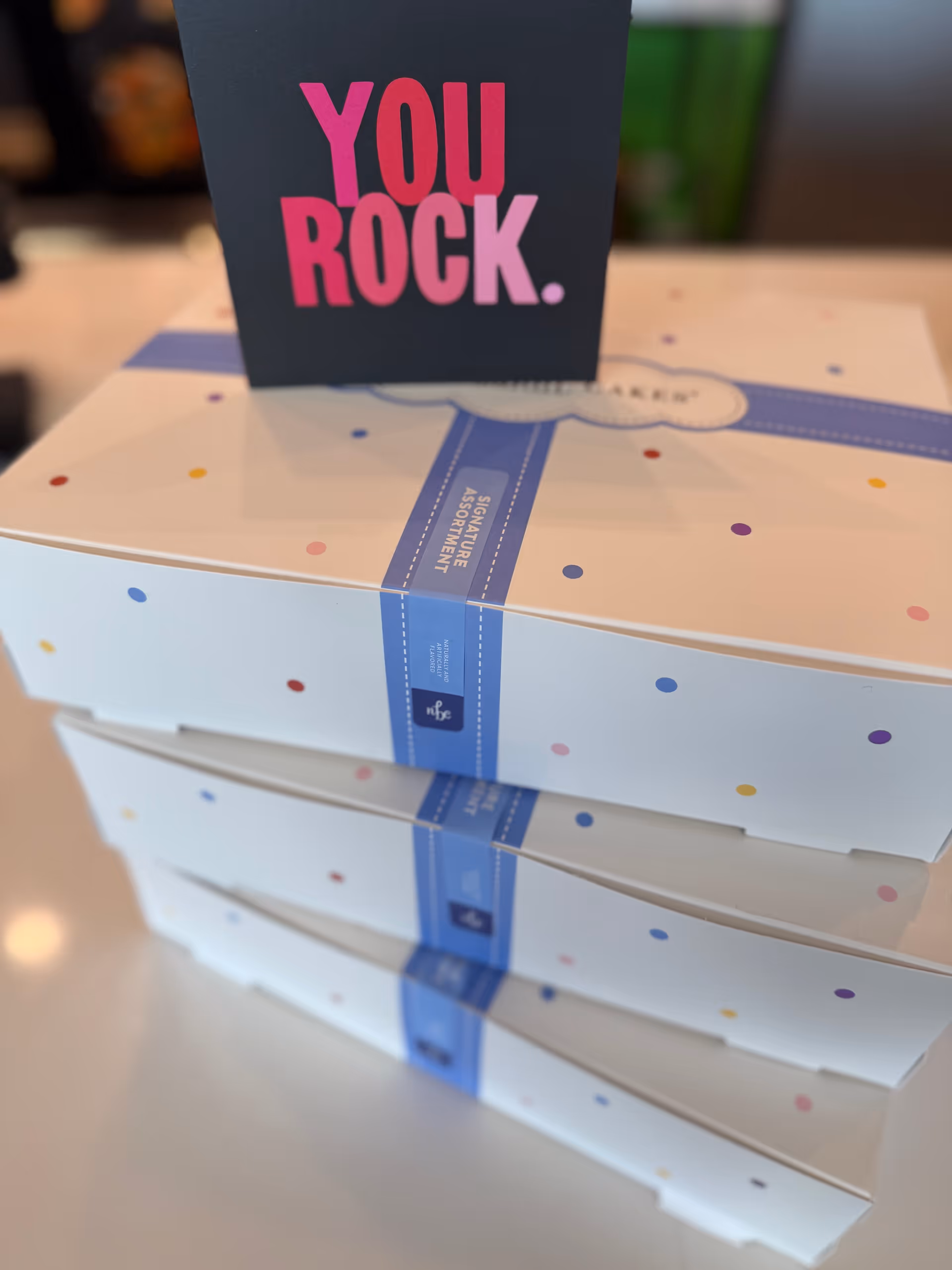 Stack of pastel gift boxes with a You Rock card on top.