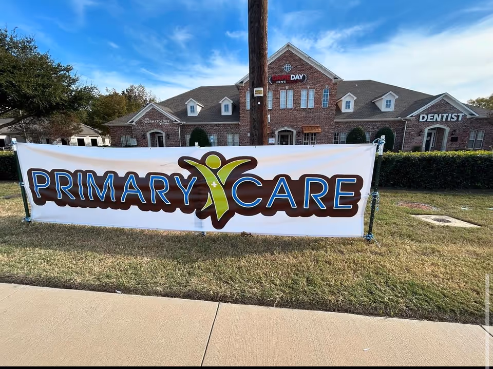Brick medical building with a large Primary Care banner in front.
