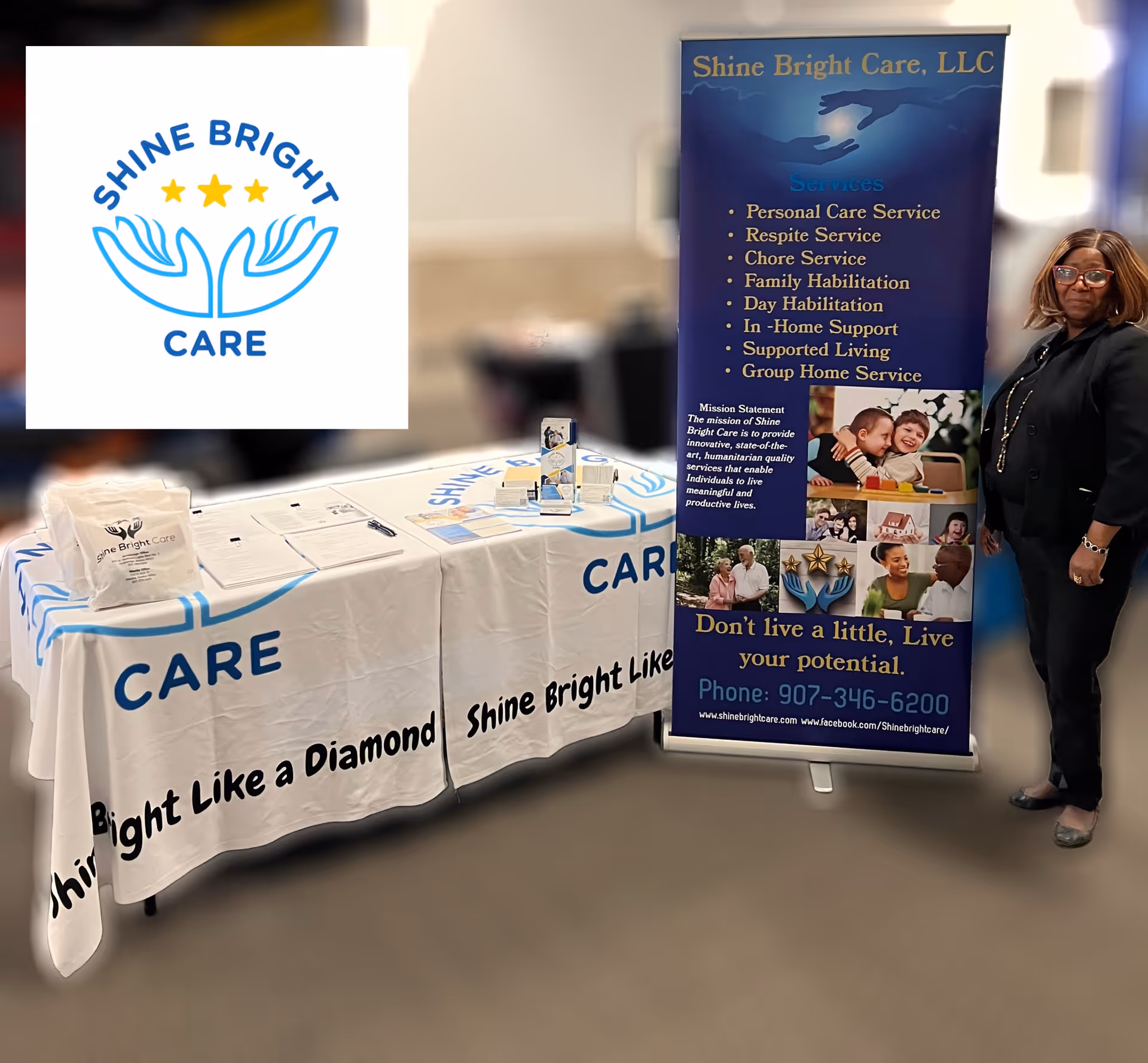 Indoor promotional booth for Shine Bright Care with banner and staff beside a table.