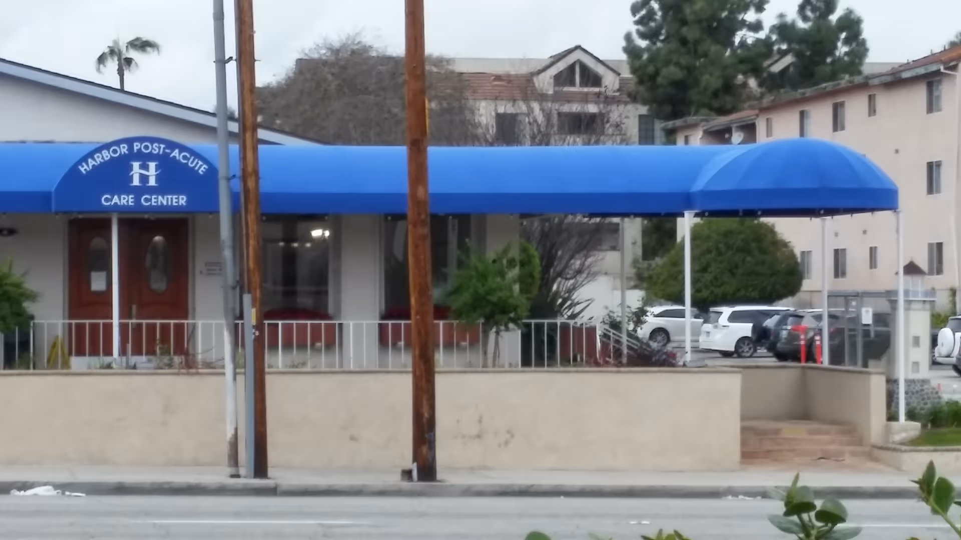 Front view of Harbor Post-Acute Care Center with a blue canopy over the entrance.