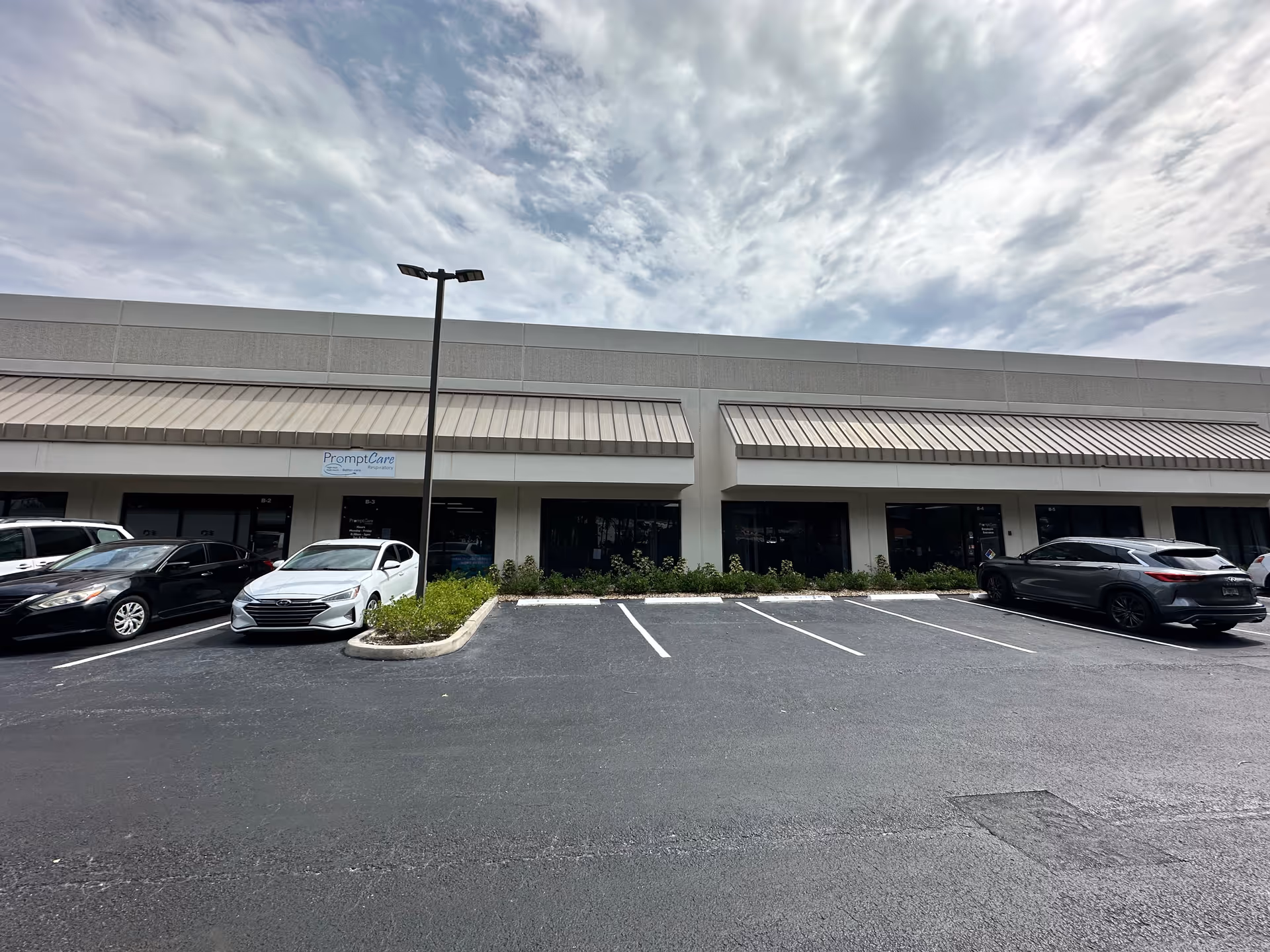Exterior view of a building front with a PromptCare Respiratory storefront.