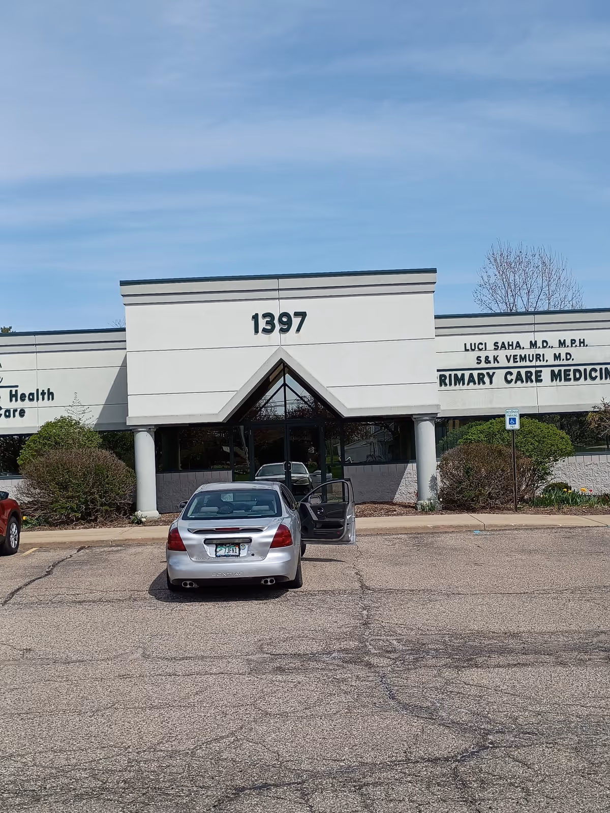 Front view of a medical facility with address 1397 and a car in the parking lot.
