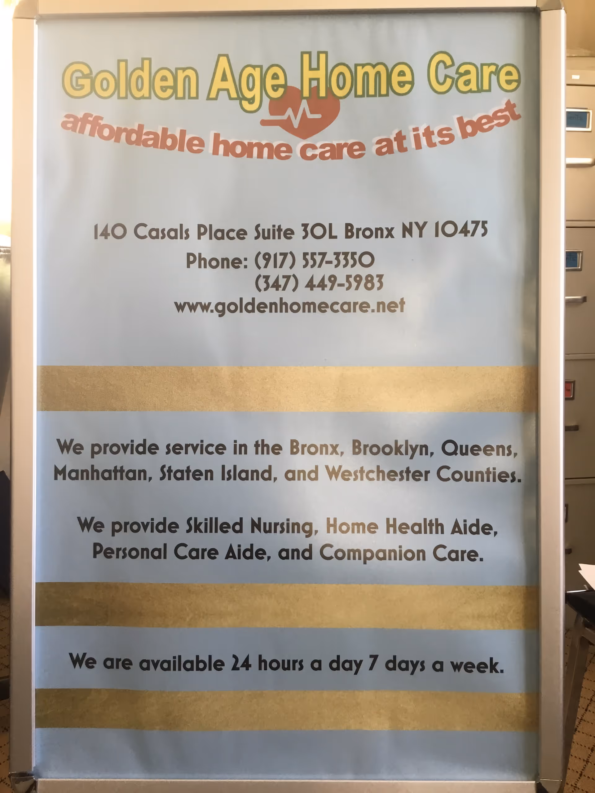 Framed sign inside a facility displays Golden Age Home Care logo, contact info, and slogan.