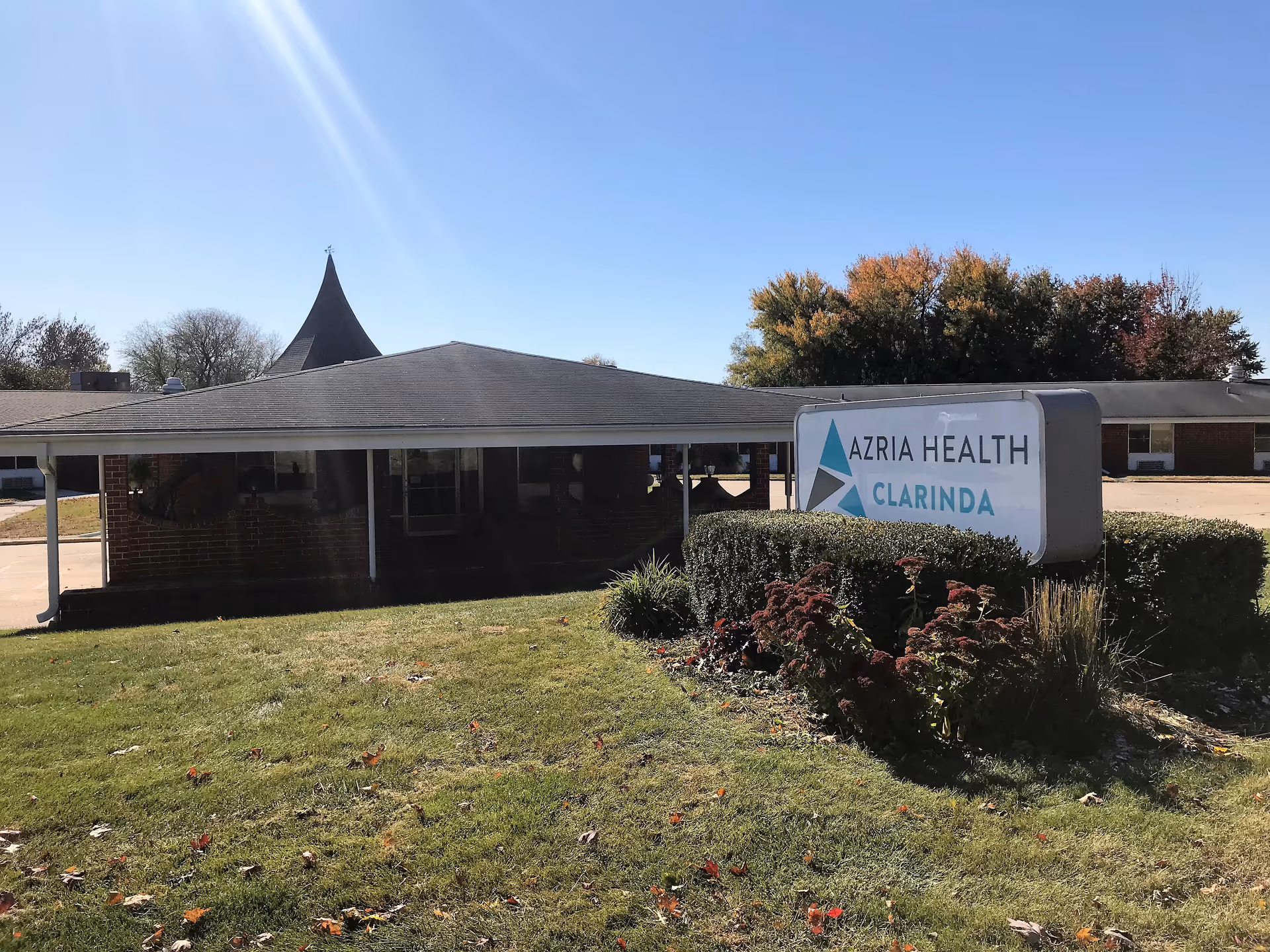 Single-story brick facility with a curved roof and a sign reading Azria Health Clarinda in front.