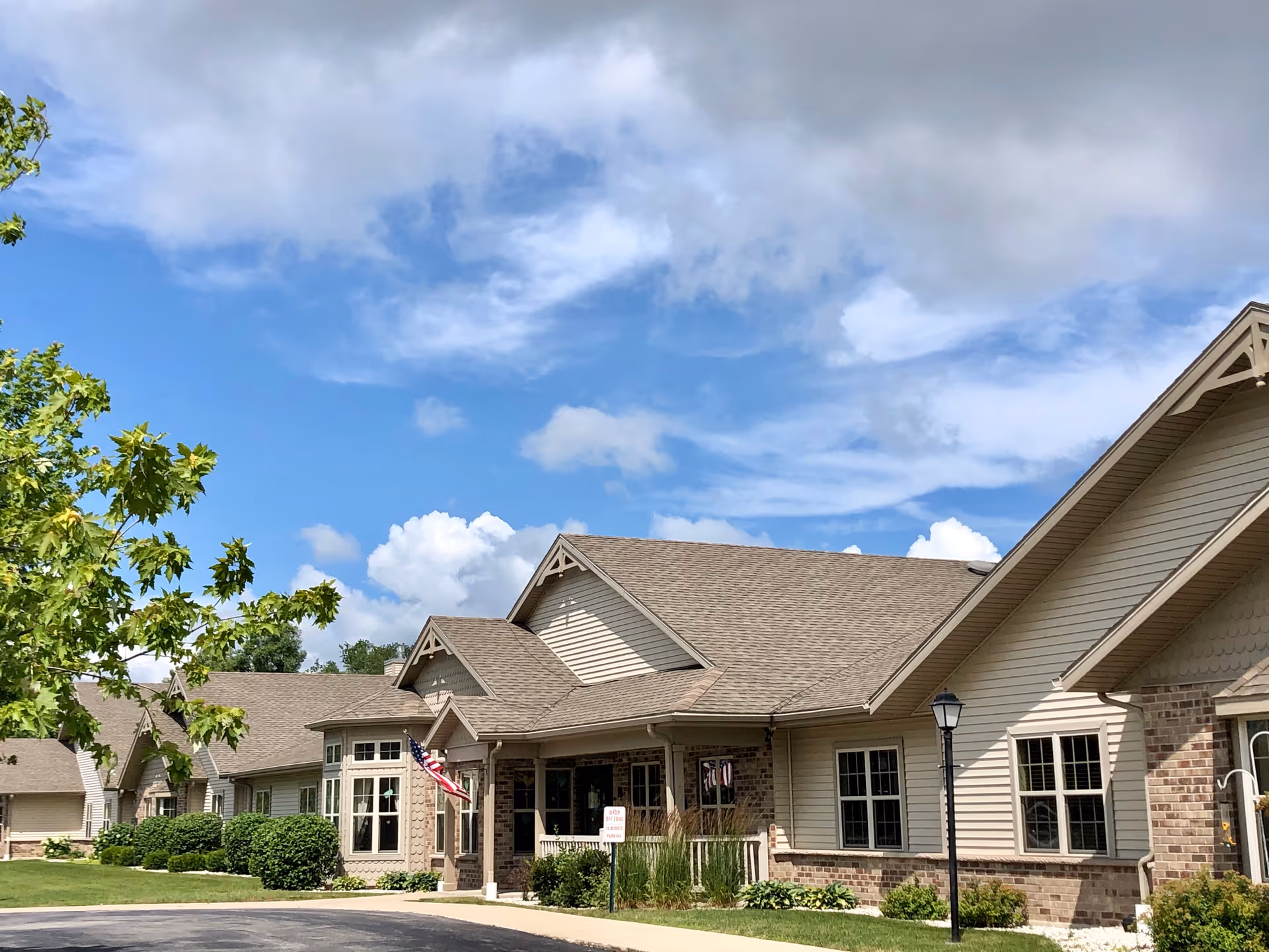 Exterior view of The Waterford at Plymouth senior living facility with landscaping.