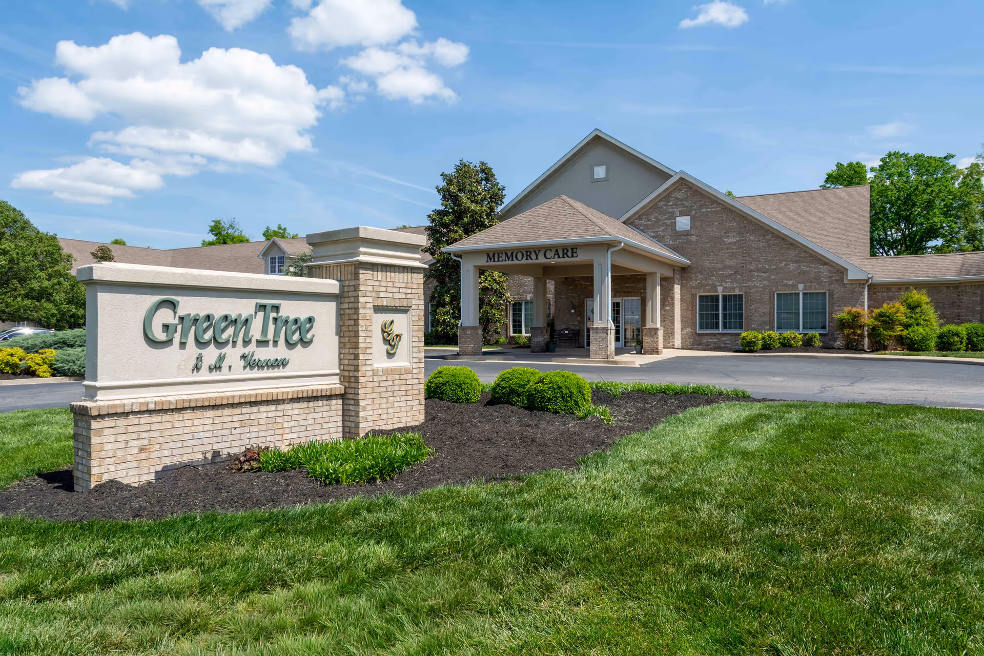 Exterior view of GreenTree at Mt. Vernon with front entrance and sign.