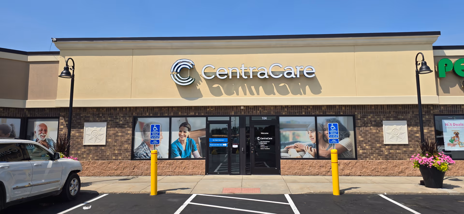 CentraCare storefront with signage, glass entrance, handicap parking, and a parked SUV.
