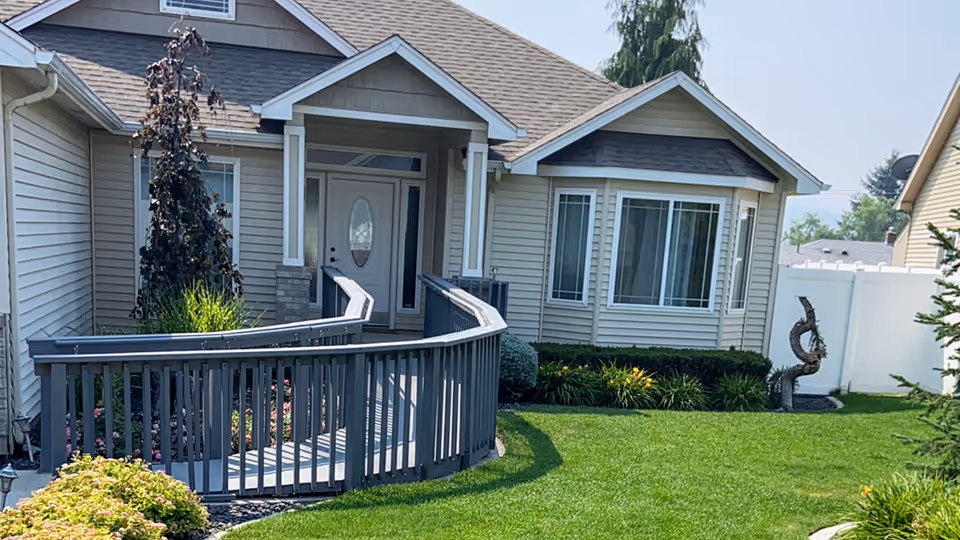 Front exterior of a single-story residence with curved ramp to the entrance.