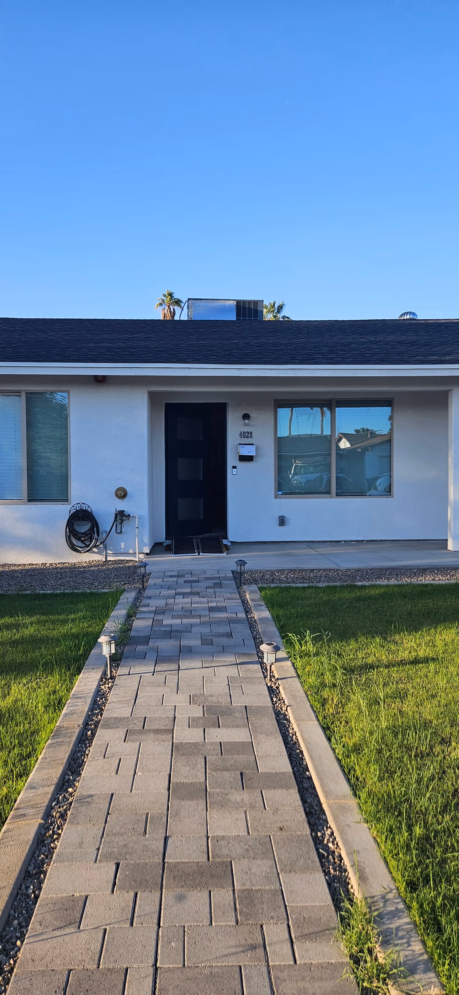 Front entrance of Aspire Care Home, LLC with a paved walkway to the door.
