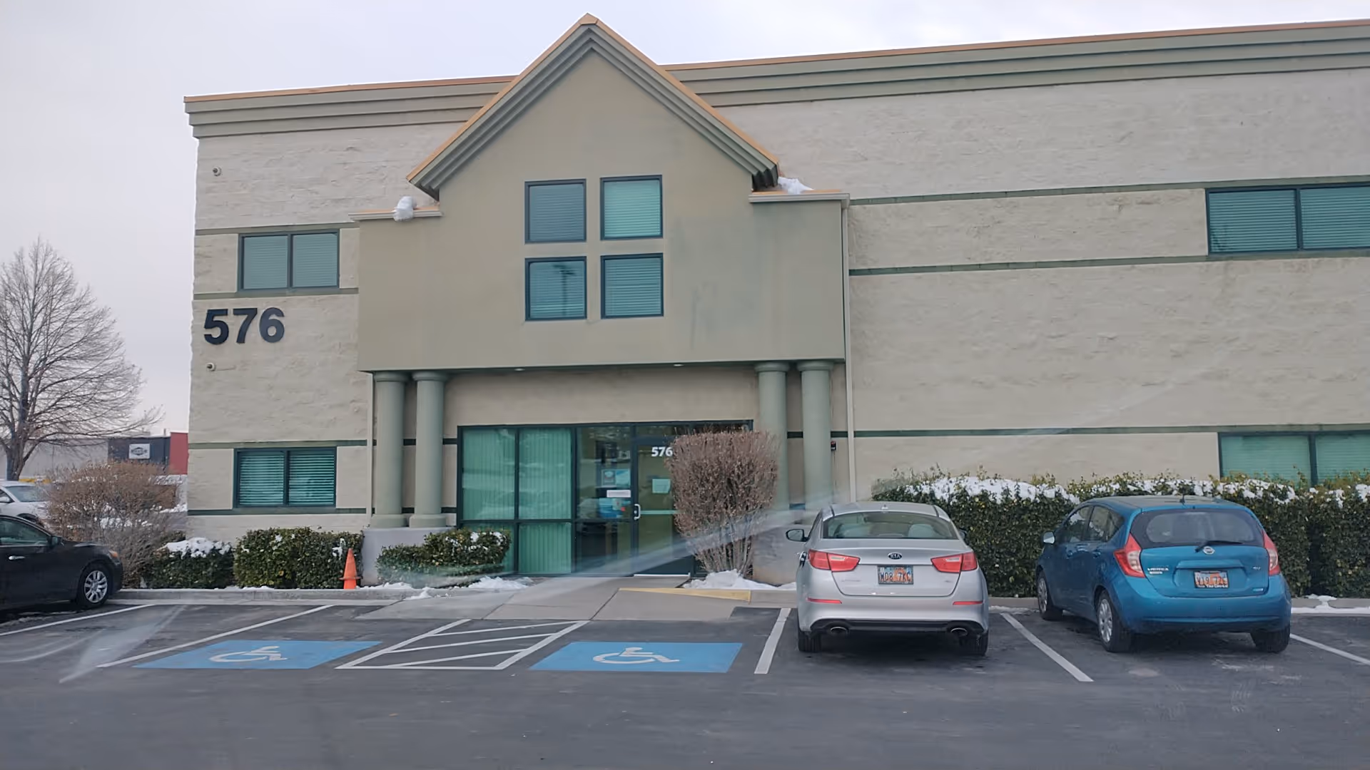 Exterior view of a Rocky Mountain Care facility with a parking lot and entrance.