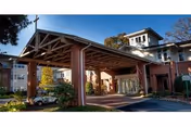 Exterior view of St. George Village entrance with brick facade and covered entry.