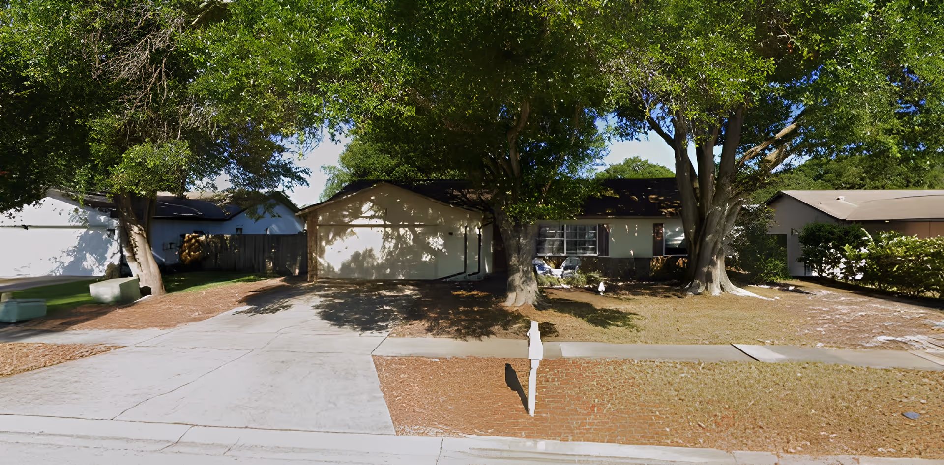 Exterior view of a senior living facility surrounded by trees.