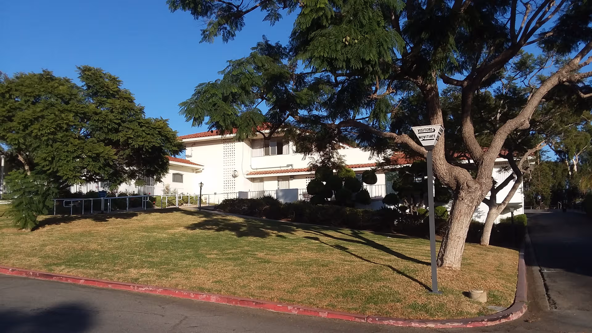 Front view of Marycrest Manor exterior with trees and a grassy lawn