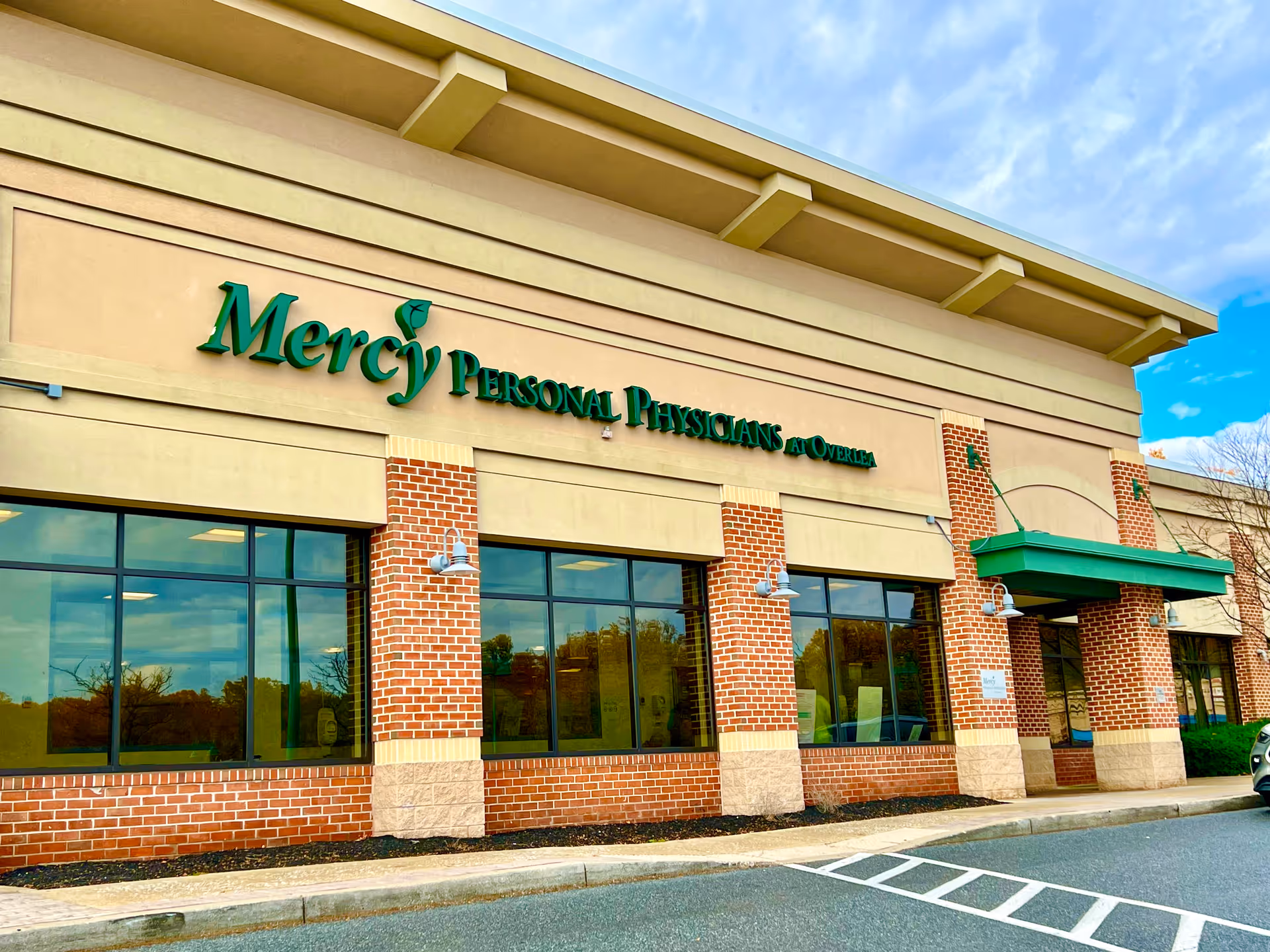 Mercy Personal Physicians at Overlea exterior with brick columns and glass storefront