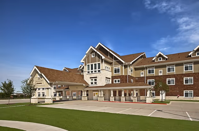 Front exterior view of The Ivy at McKinney senior living facility with a welcoming entrance.