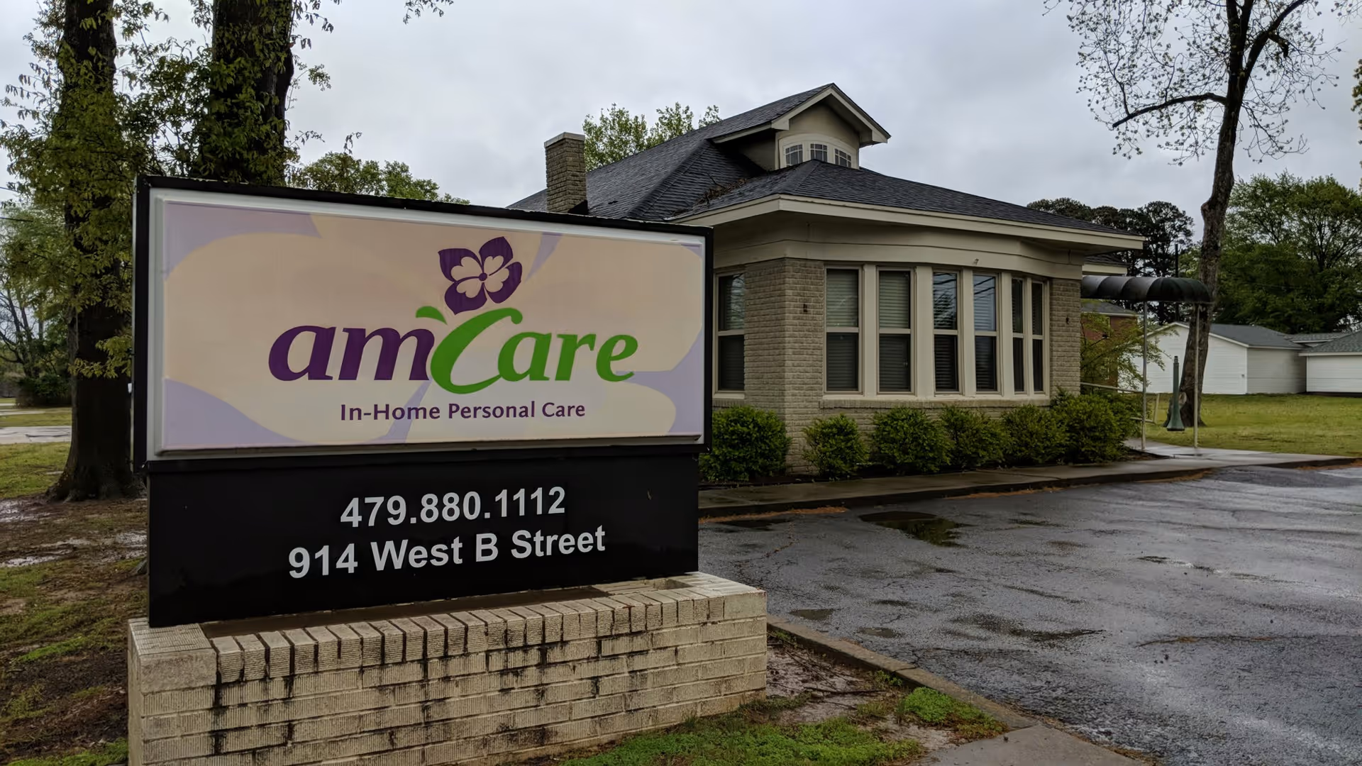 Exterior view of AmCare sign in front of a brick facility.
