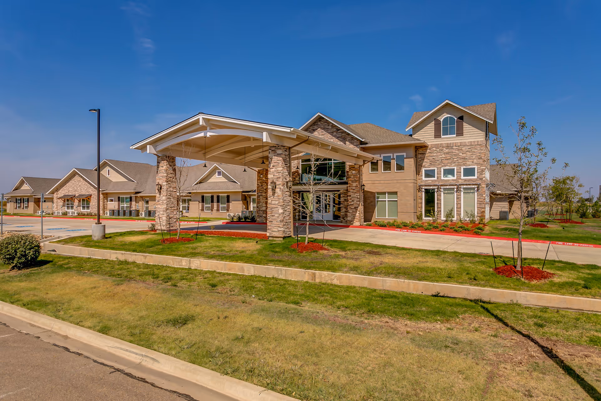 Exterior view of Bristol Park at Amarillo Assisted Living Memory Care building with entrance canopy.