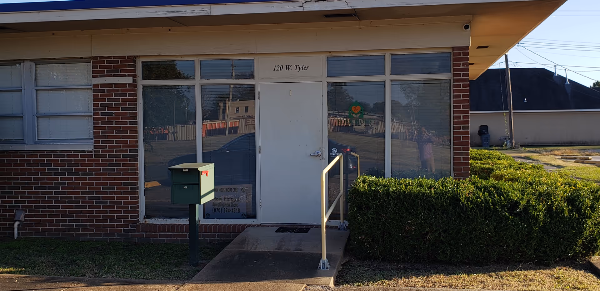 Front exterior of Eden House Home Care LLC with brick facade, glass doors, and ramp.