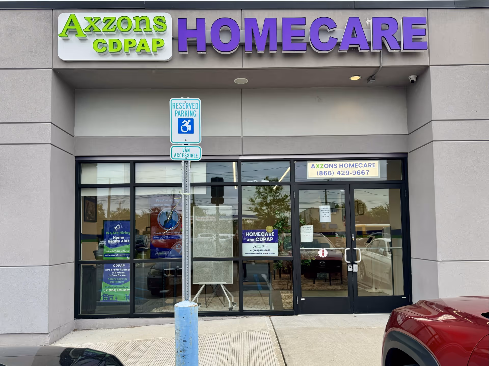 Front of Axzons Homecare storefront with large purple HOMECare sign and glass doors.