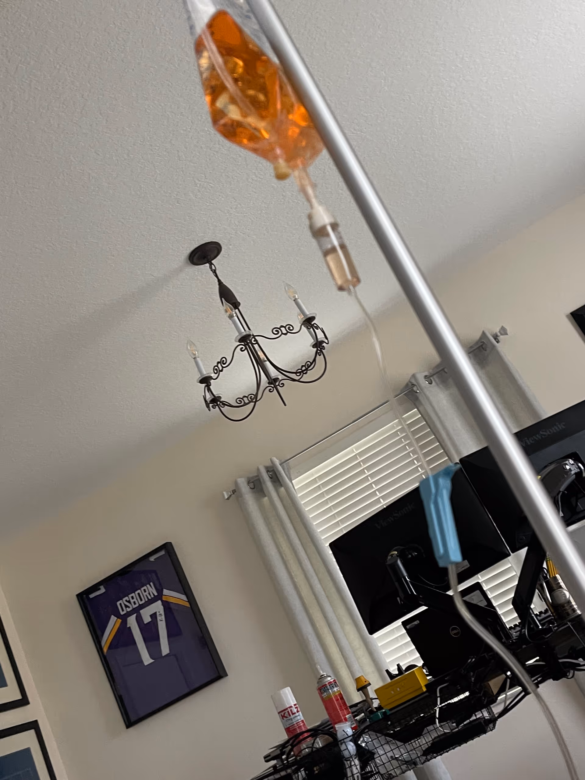 IV bag and medical equipment in a furnished room with sports jersey.