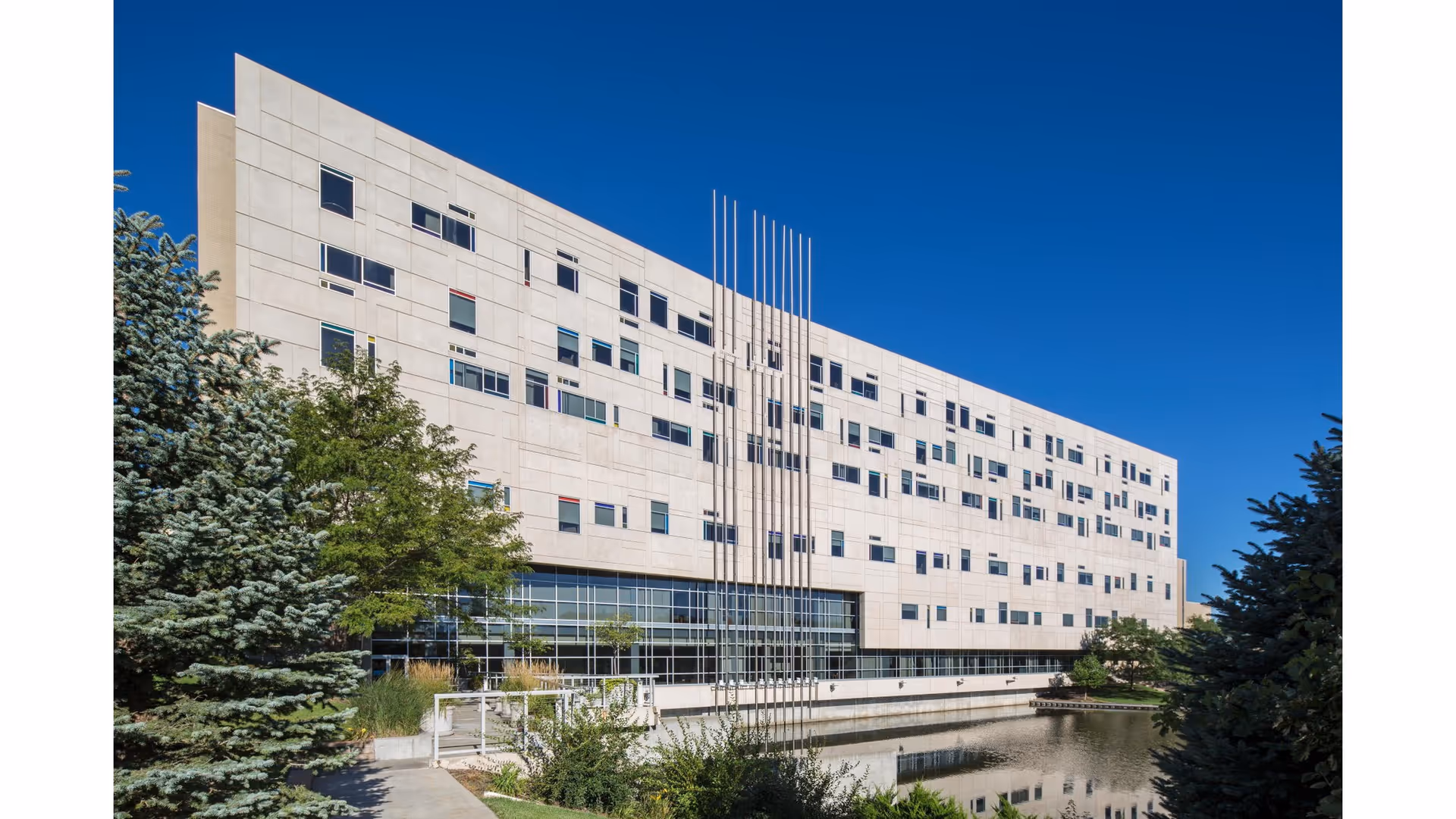 Exterior view of CHI Health St. Elizabeth Ostomy Outpatient Clinic, a modern beige multi-story building.