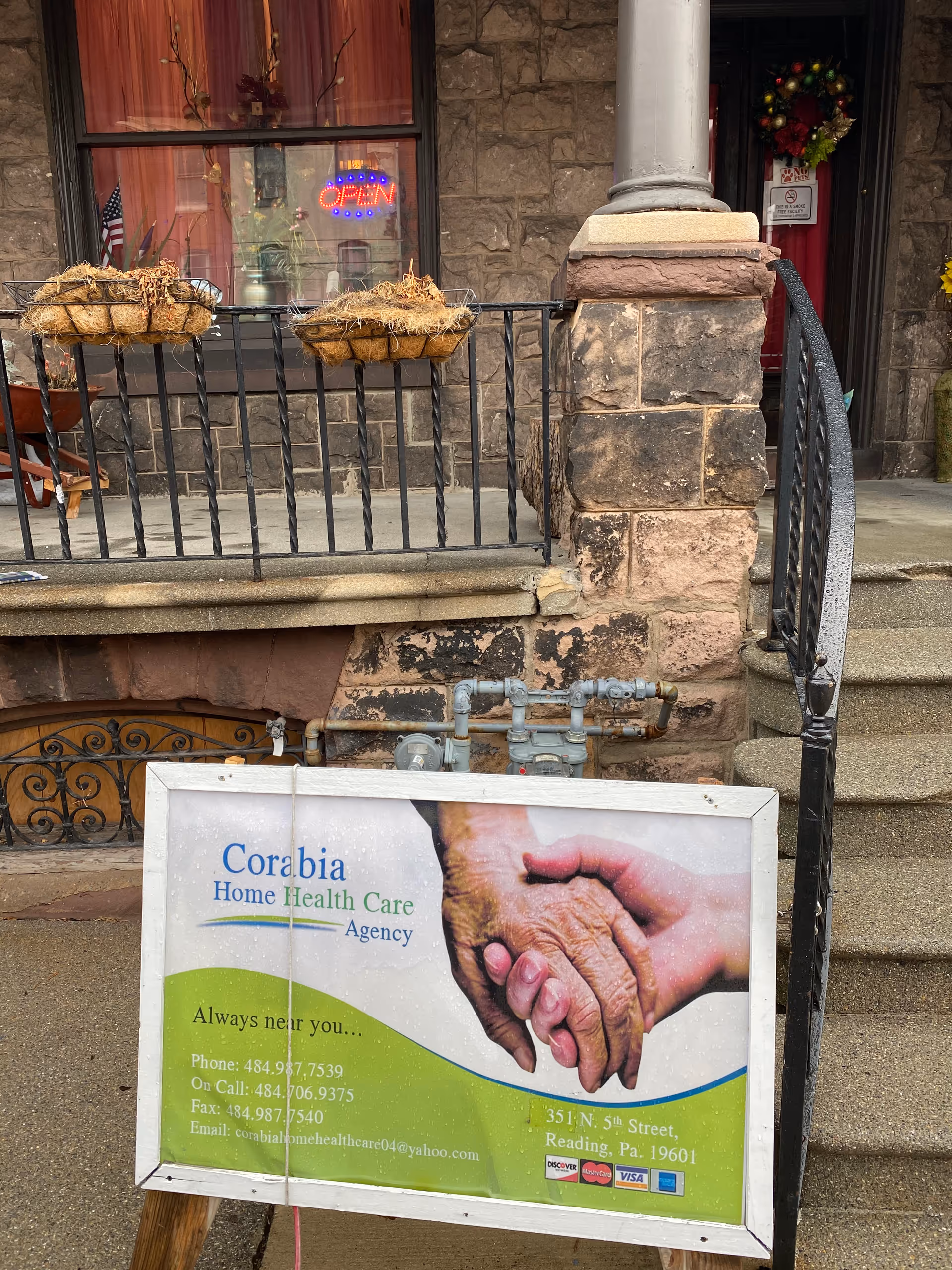 Stone exterior with front steps, railing, and a Corabia Home Health Care Agency sign.