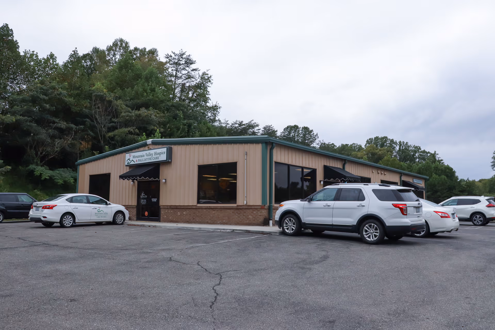 Front exterior of Mountain Valley Pilot Mountain Office with several parked cars