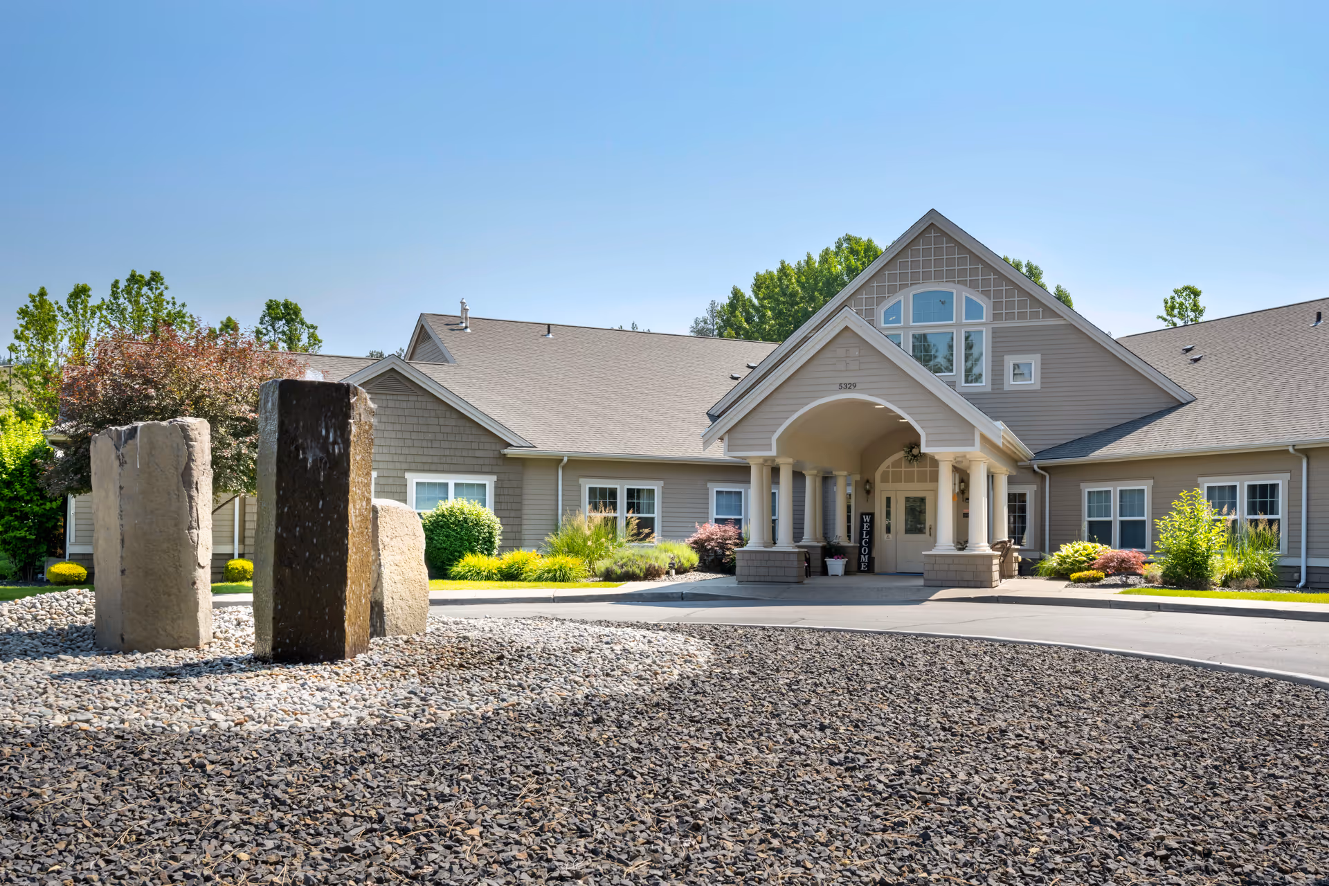 Front view of Brookdale Nine Mile senior living facility entrance with landscaped rocks.