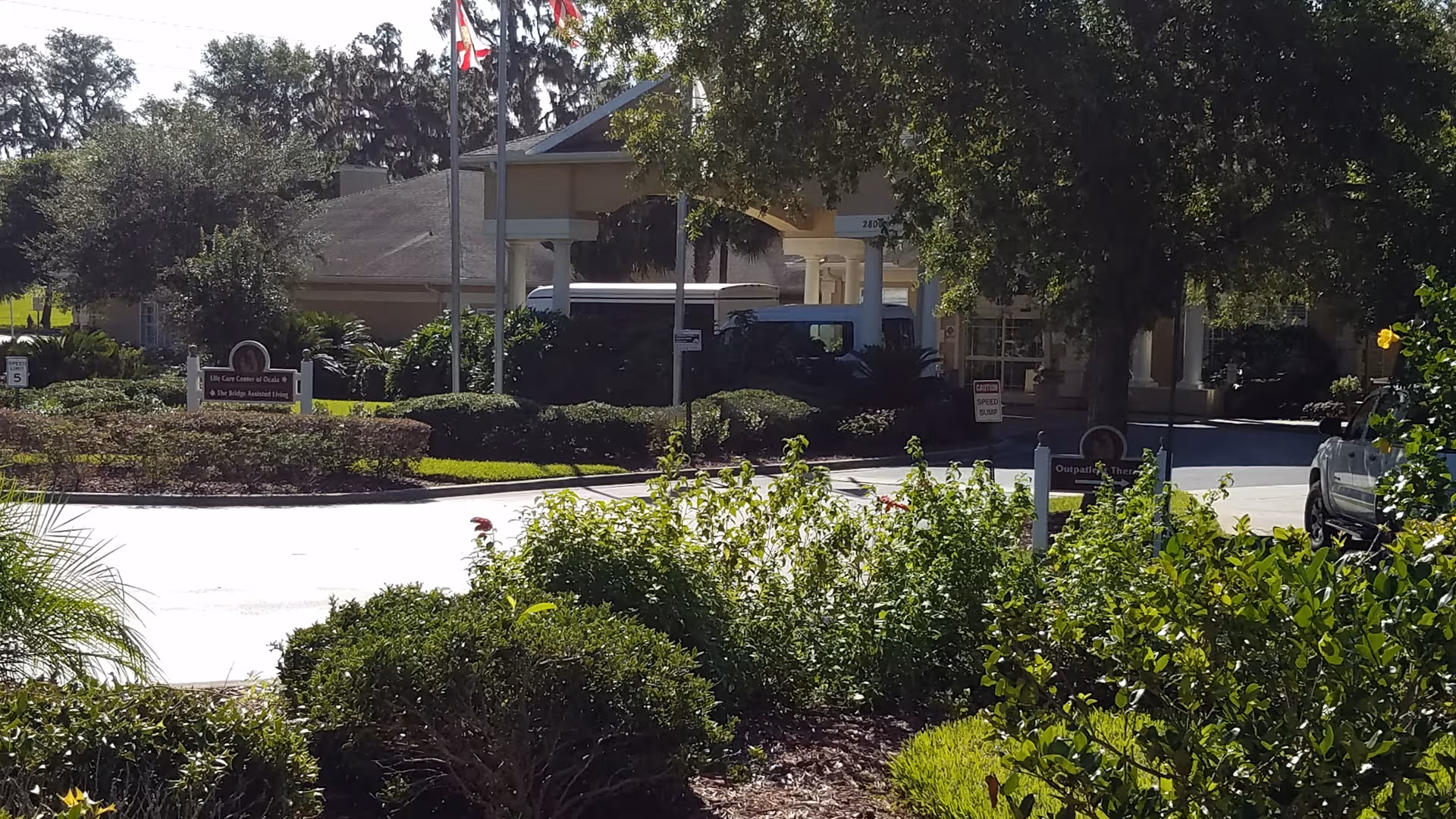 Front view of Life Care Center of Ocala with entrance, driveway, and surrounding landscaping.
