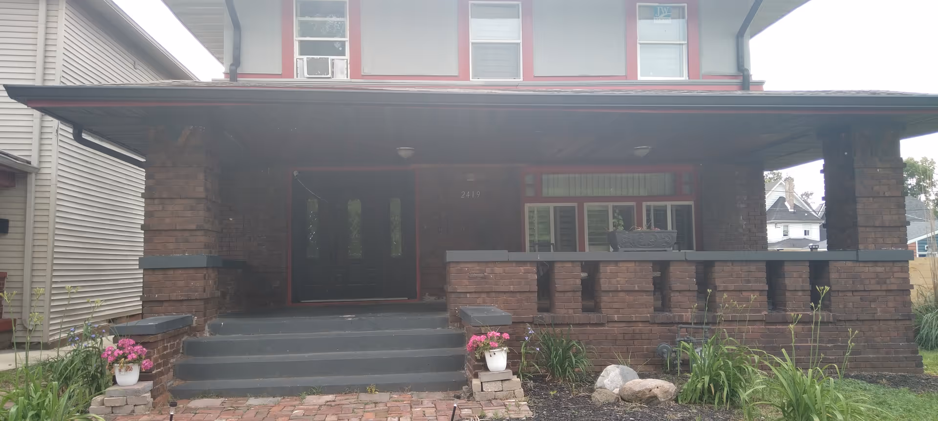 Exterior of Kristy's House of Care: brick front with a covered porch and double doors.