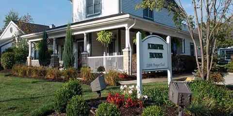 Exterior of Kemper House Strongsville with a porch, sign, and landscaped front yard.