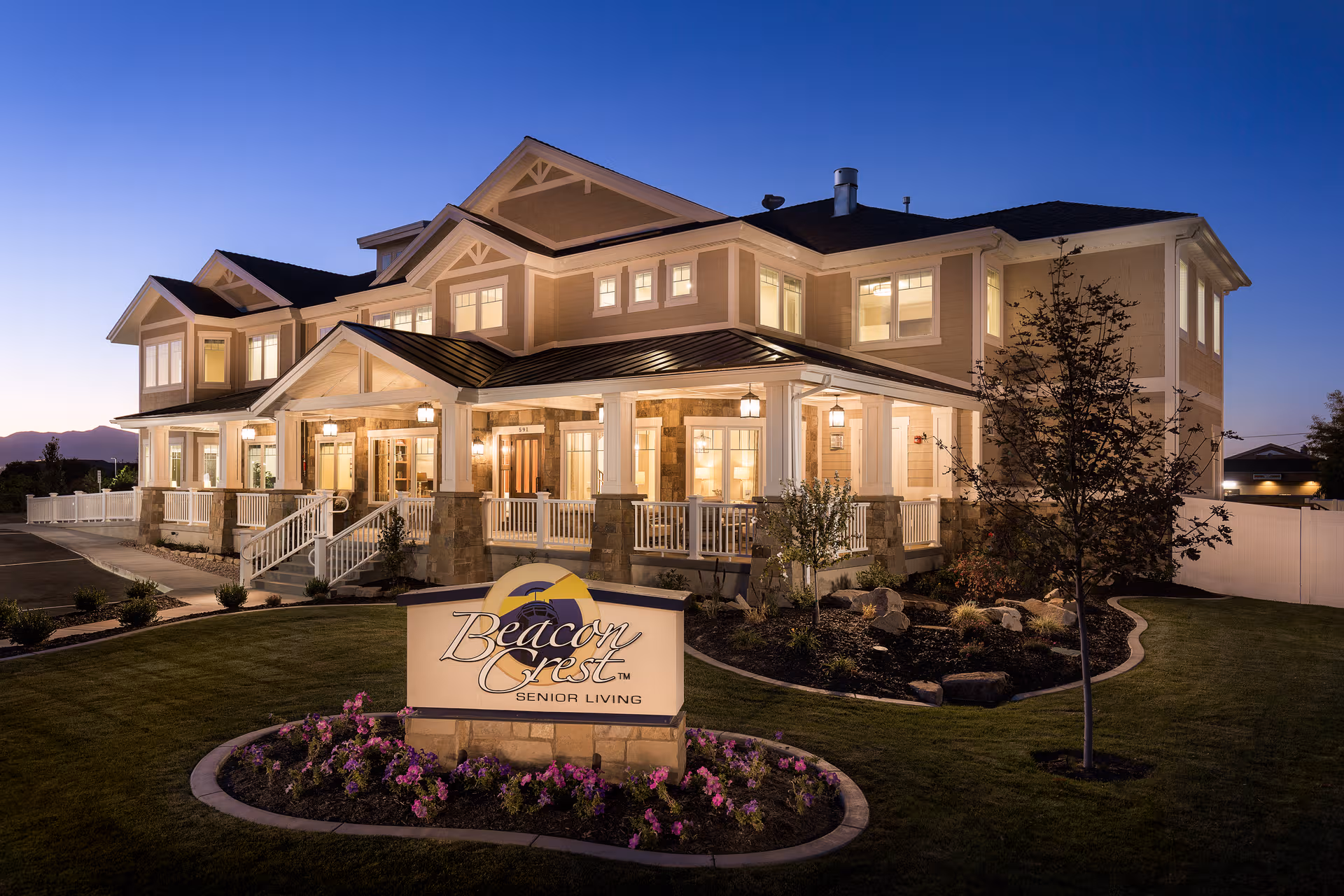 Exterior view of Beacon Crest Senior Living in Draper at dusk.
