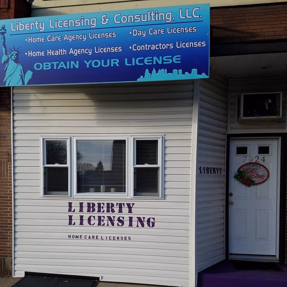 Exterior building front with Liberty Licensing & Consulting sign, white siding, windows, and door