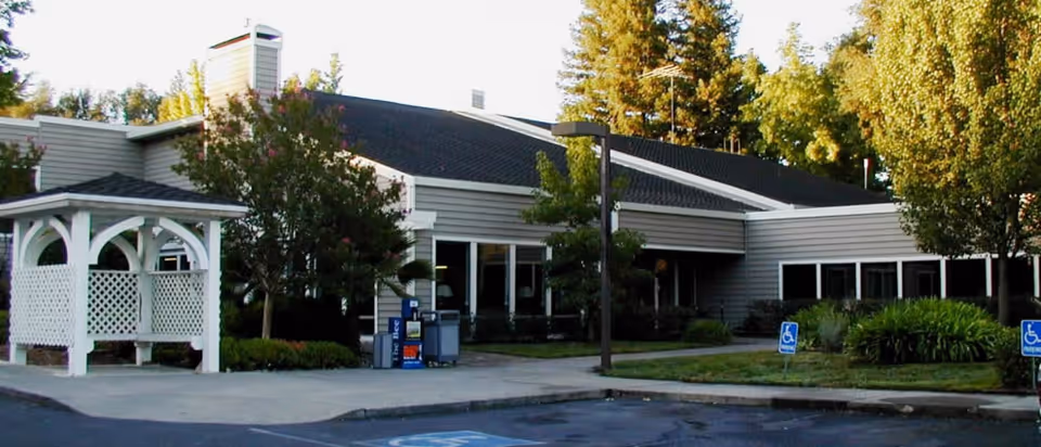 Exterior view of Eskaton Care Center Fair Oaks with entrance, parking, and landscaping.