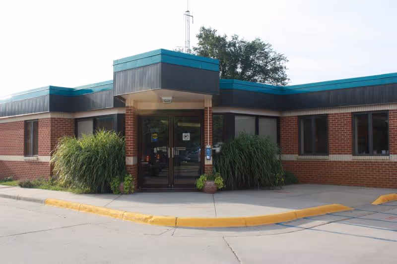 Exterior view of Stafford County Hospital entrance with brick facade, glass doors, and landscaping.