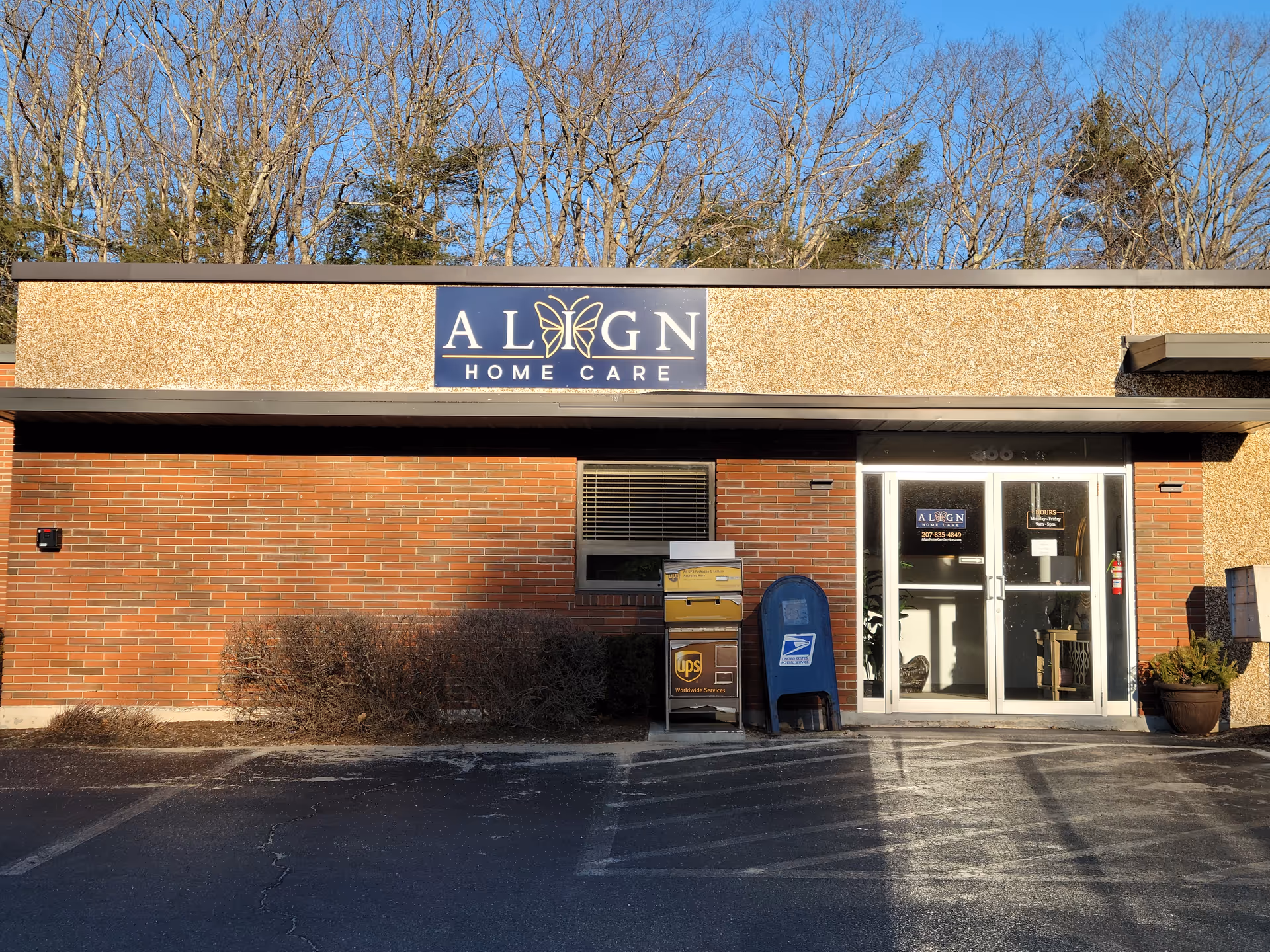 Brick facility exterior with Align Home Care entrance and signage, and blue mailbox nearby.