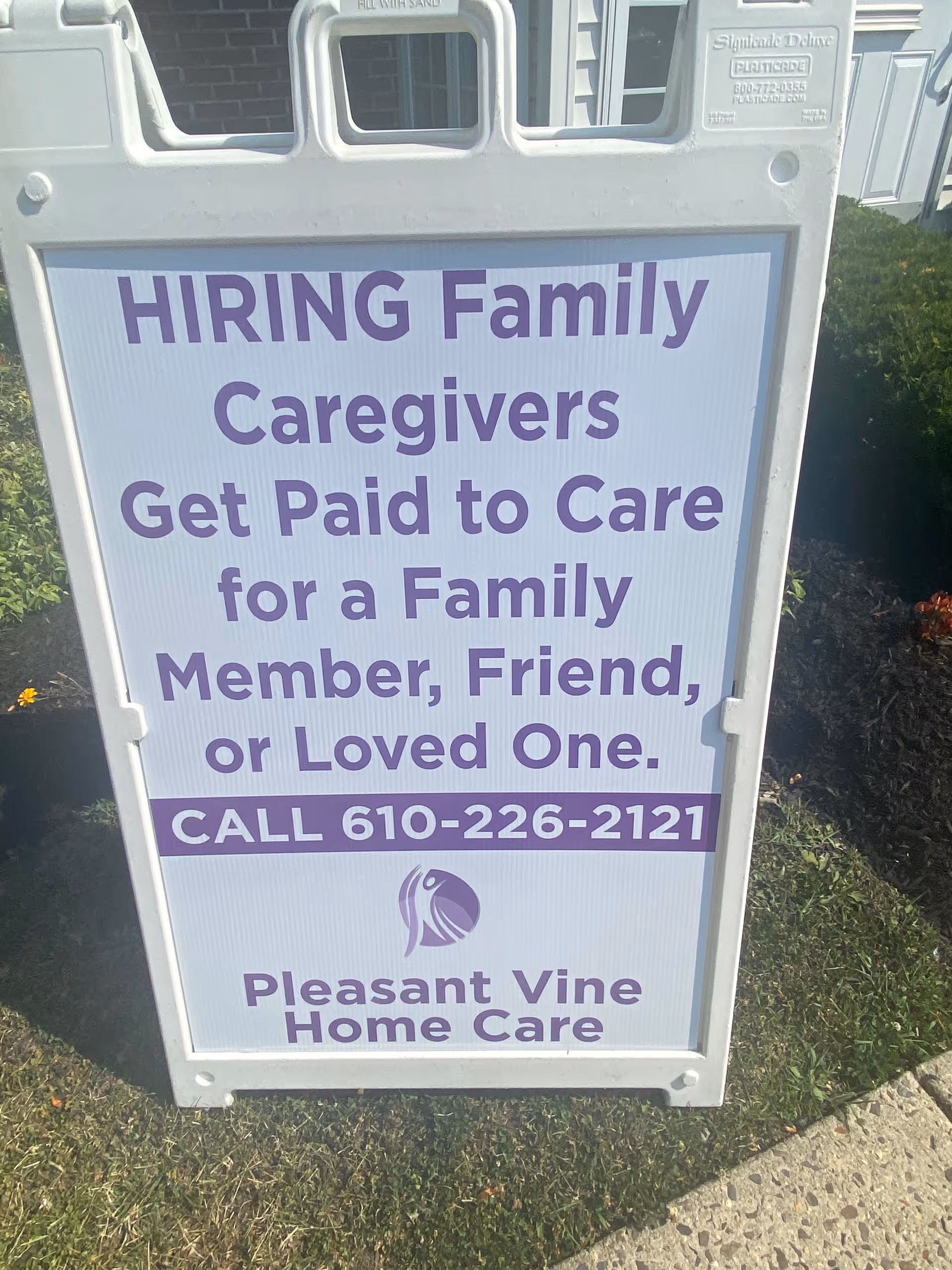 Outdoor sign advertising caregivers for Pleasant Vine Home Care.