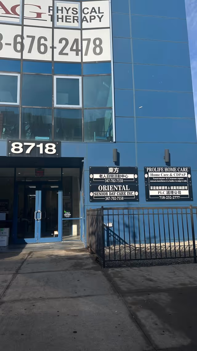 Blue glass-front building exterior with entrance and multiple ProLife Home Care signs on the facade.