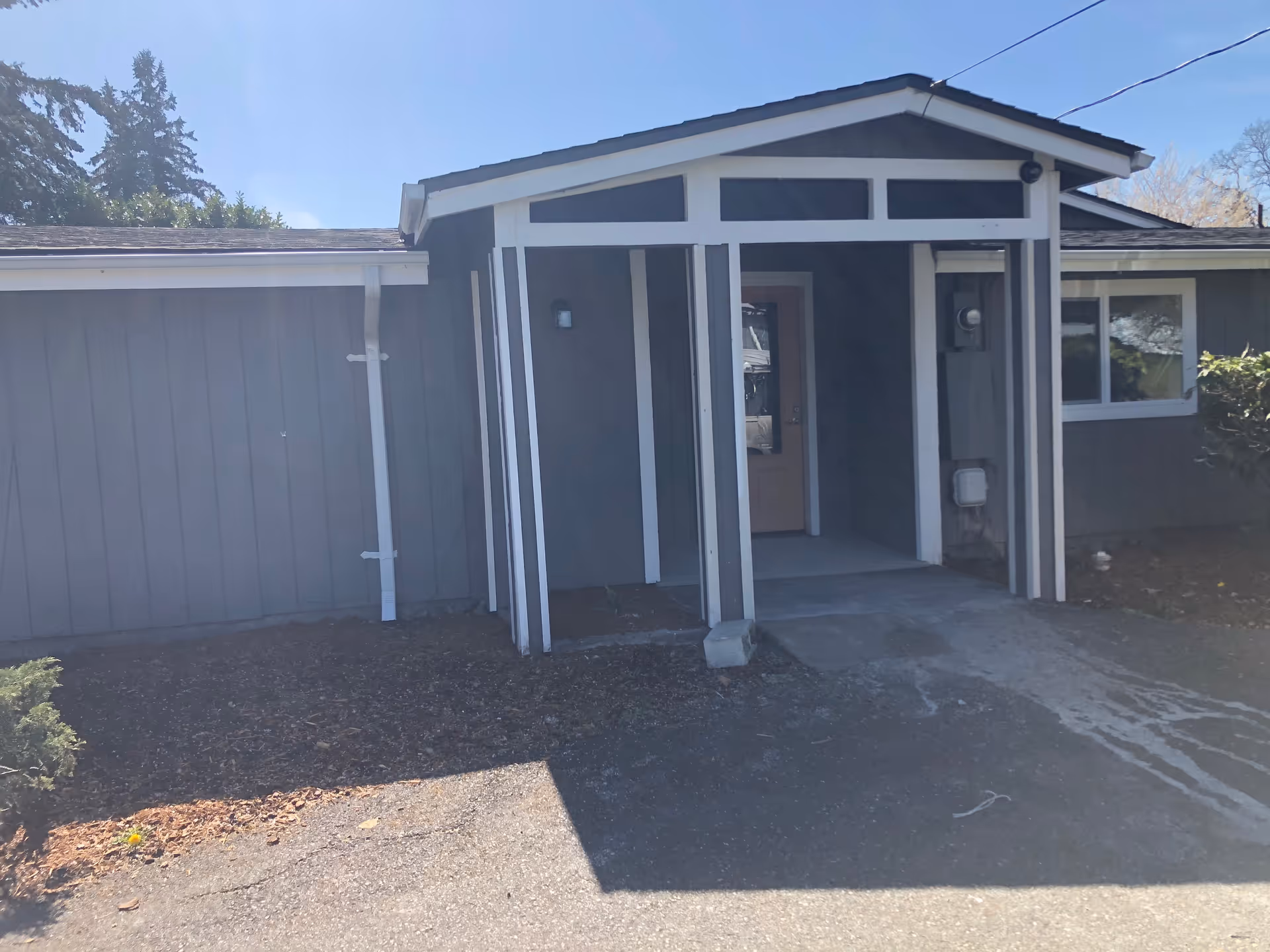 Small single-story residential-style building with a front porch entrance.